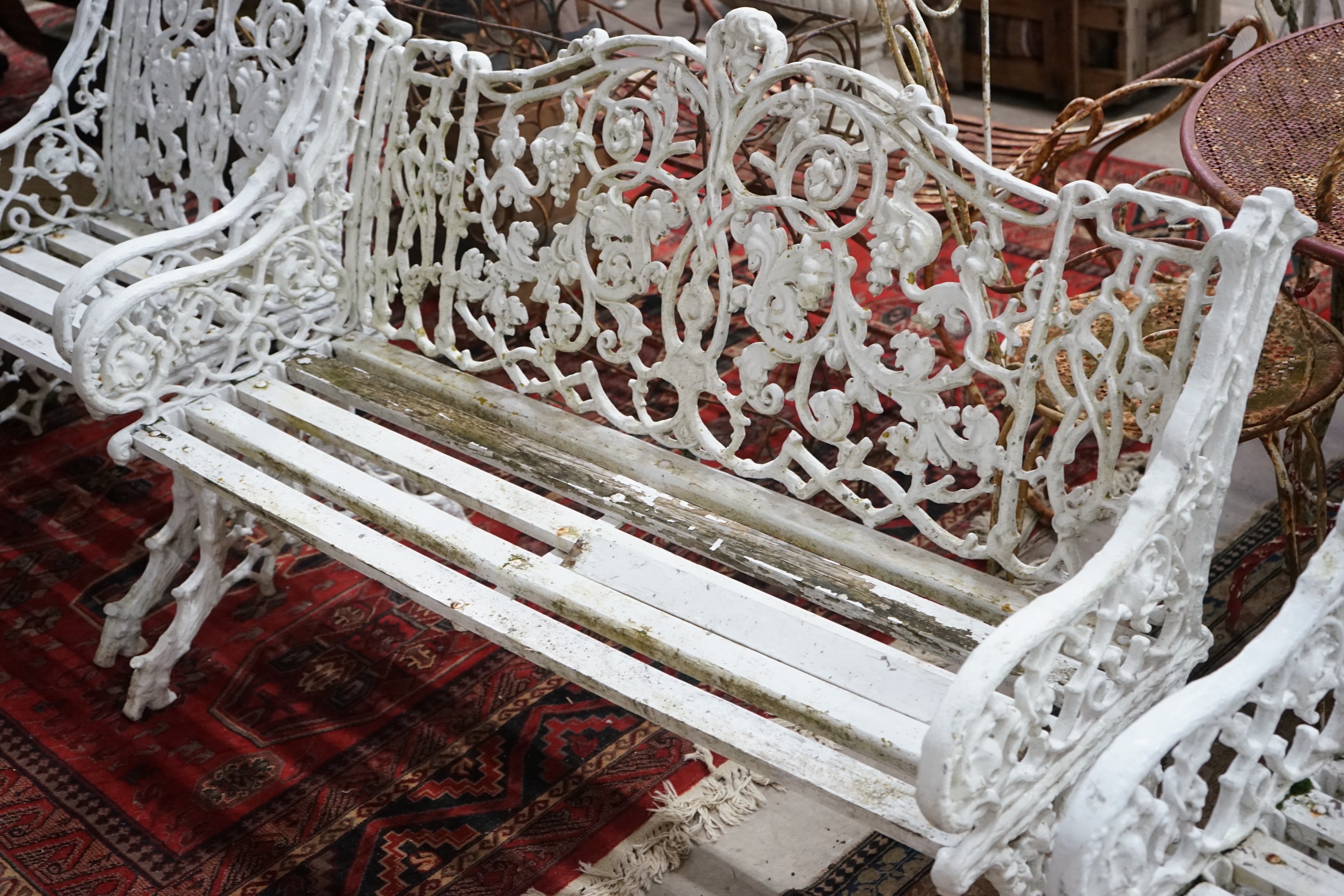 A Victorian style cast metal slatted garden bench, length 127cm, depth 60cm, height 86cm and two chairs